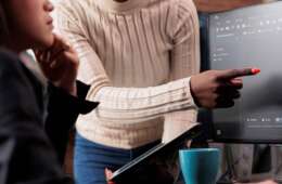 african-american-software-developer-pointing-out-cloud-database_s